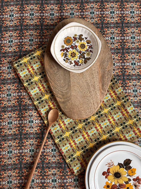 Many Suns Tea Towel in vibrant yellow, artist-designed and sustainably made from organic cotton, adding timeless charm to your kitchen.