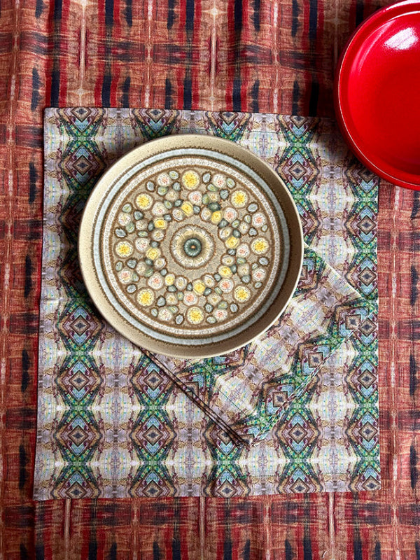 Artist-designed cotton-linen napkins with soft hues, perfect for mixing and matching with tablecloths. Quality and sustainability meet elegance.