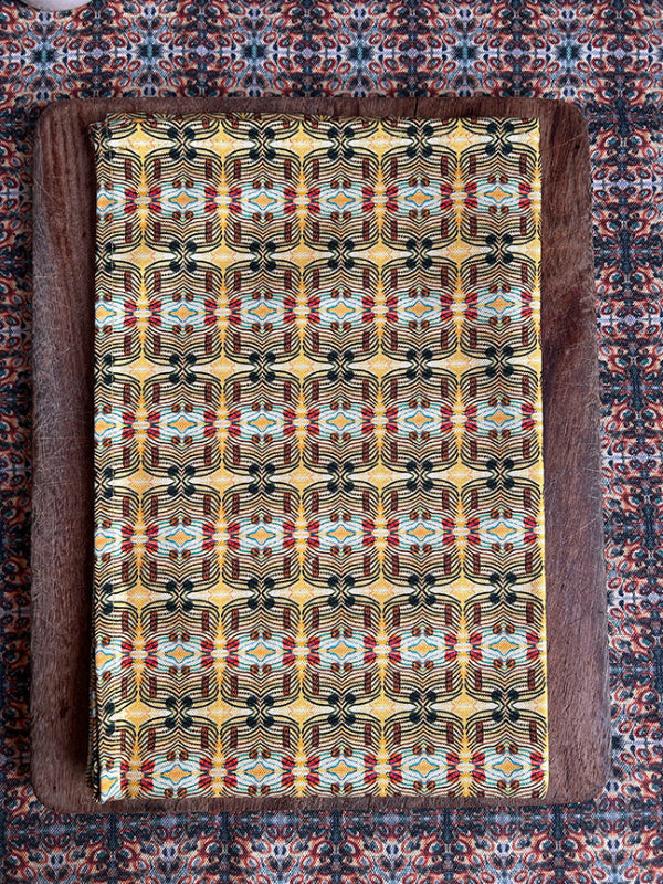 Luxury Many Suns Tea Towel, handmade in the UK, showcasing premium quality and vibrant yellow tones on eco-friendly, organically sourced cotton.