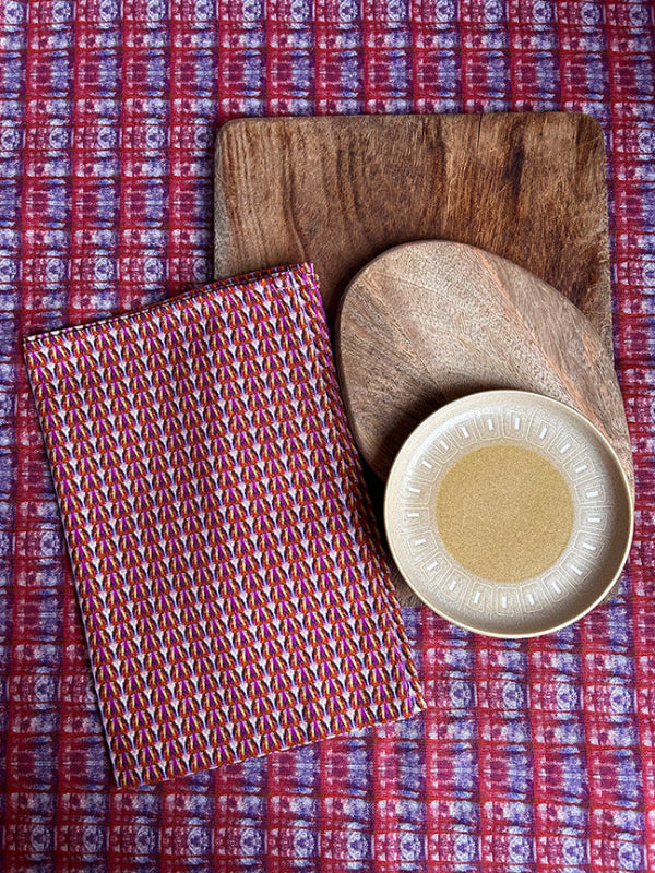 Pop Pop Candy Tea Towel in bold purple, artist-designed and crafted from 100% organically sourced cotton, folded neatly in eco-friendly plastic-free packaging.