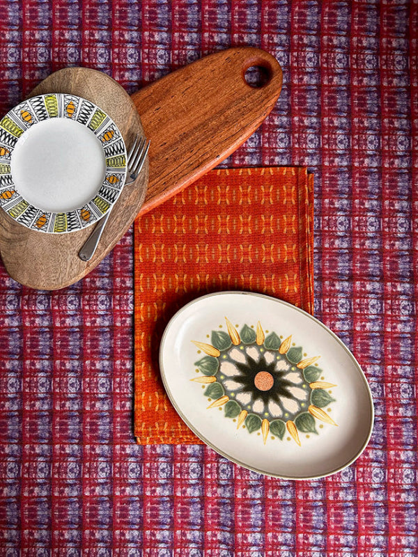 Red Dandelions Tea Towel showcasing bright red hues, eco-friendly packaging, and premium craftsmanship.