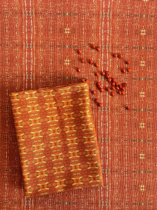 Full view of the Red Dandelions artist-designed luxury tea towel, folded neatly with a paper belly band.