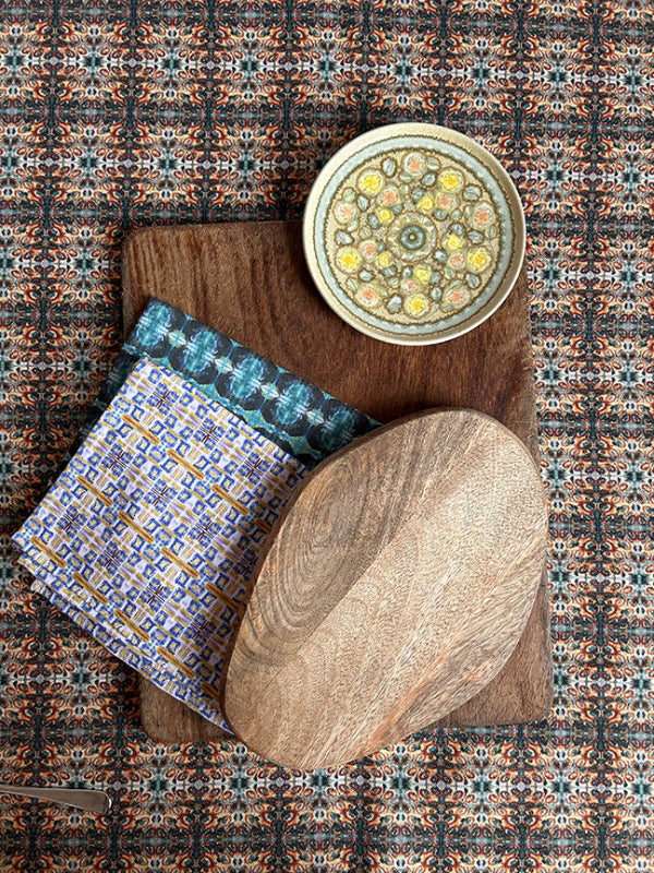 Light Cotton Tea Towel set in soft pink, blue, and yellow tones, artist-designed and crafted from 100% organic cotton, folded with eco-friendly packaging.