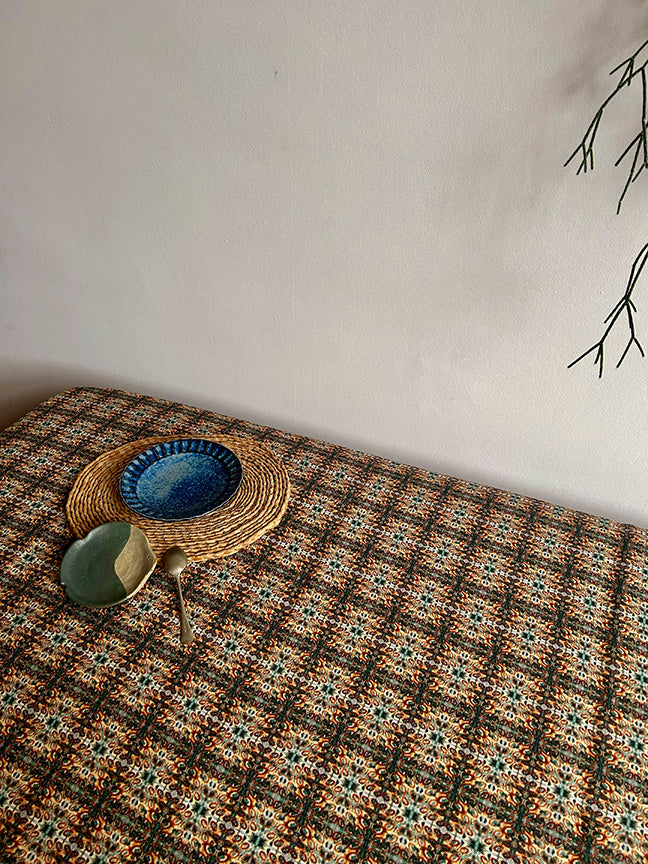 Artist-designed Hedgerow Cotton and Linen Tablecloth, packaged plastic-free, with sizes for casual or formal dining, blending beauty and practicality.