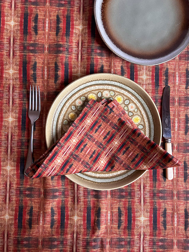 Luxury artist-designed cotton napkins in red, blue, and brown, made from 100% cotton. Vibrant, sustainable, and handcrafted in the UK, ideal for dining occasions.