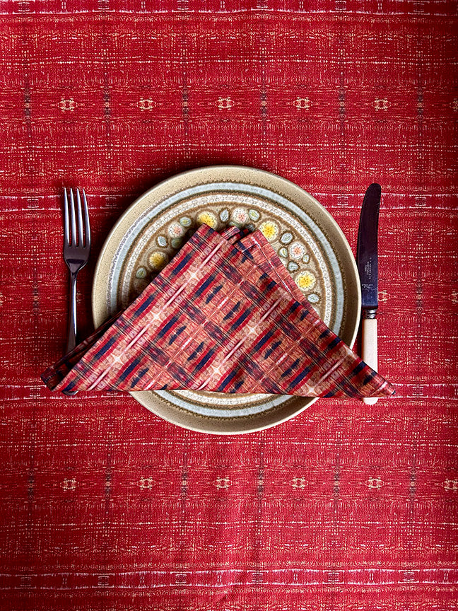 Luxury artist-designed cotton napkins in red, blue, and brown, made from 100% cotton. Vibrant, sustainable, and handcrafted in the UK, ideal for dining occasions.